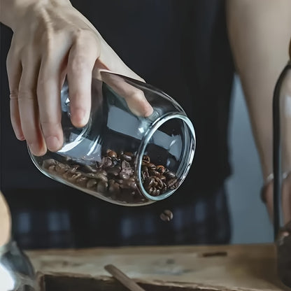 Airtight glass kitchen jars with cork lids for coffee, tea, and spices.