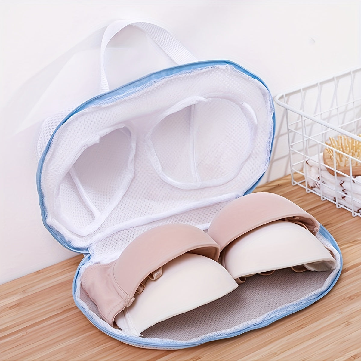 Mesh laundry bag with zipper closure for delicate clothing, durable and round-shaped, made of woven material.