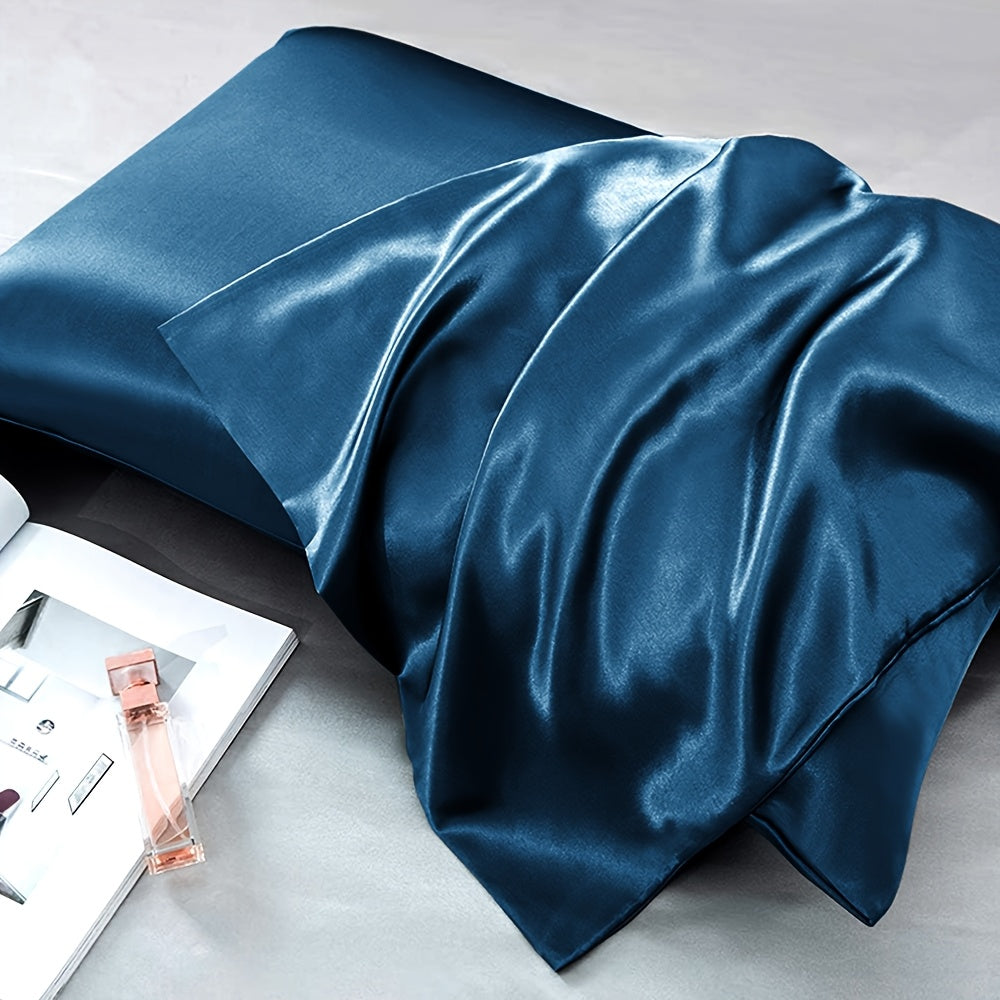 Two-pack of luxurious silky satin pillowcases, made from ultra soft smooth polyester with an envelope closure design. Available in solid colors, these machine washable pillow covers are lightweight at 80-85gsm, providing cooling comfort for hair and