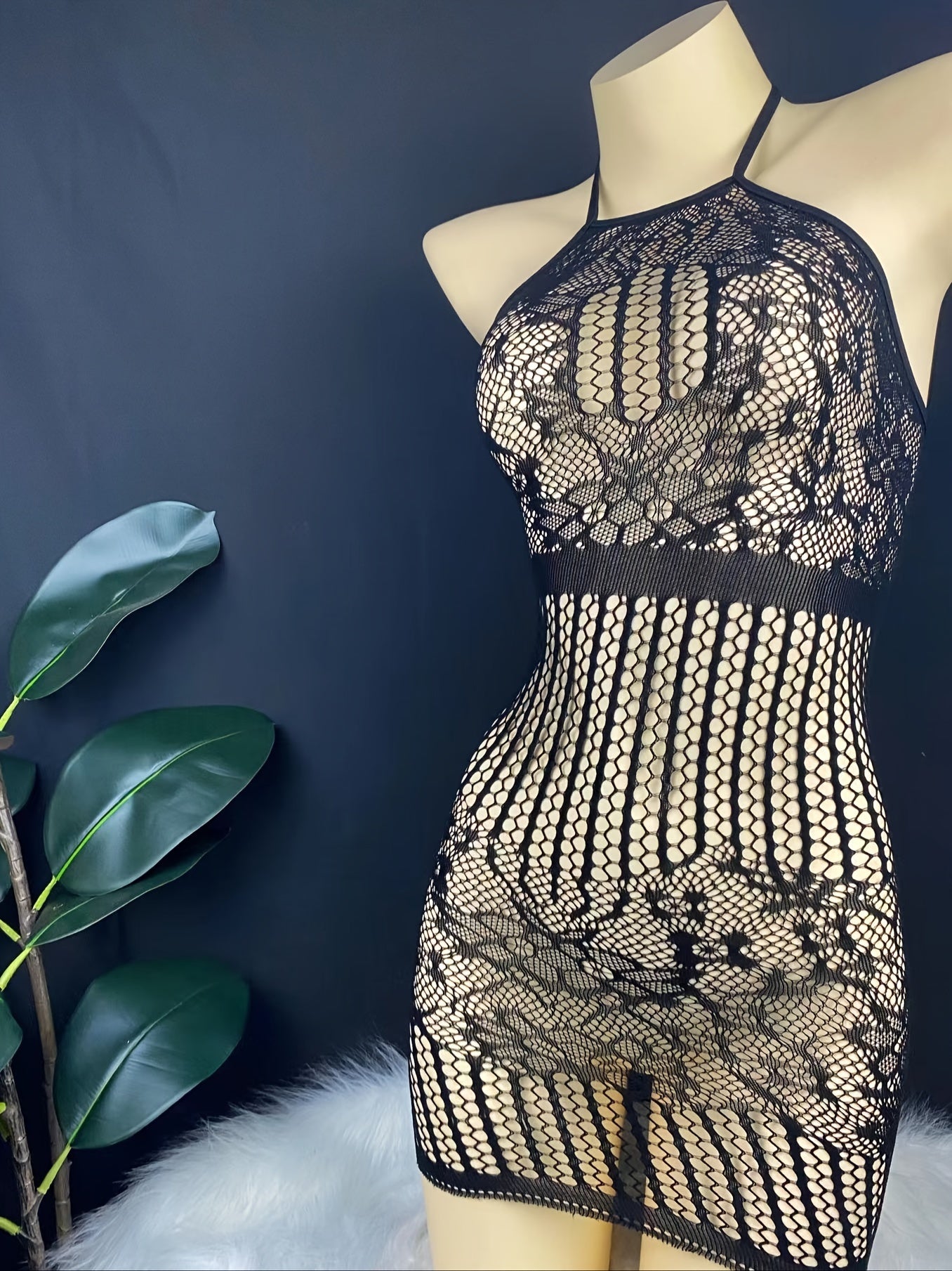 Seductive halter bodysuit with lace mesh details and a backless design, perfect for a daring look. Made of a nylon and elastane blend.