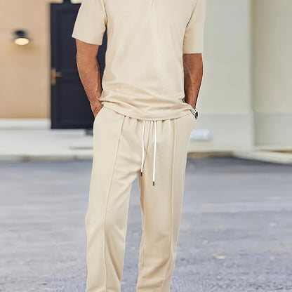 Men's casual outfit with waffle knit short sleeve zip-up shirt and drawstring pants in black. Made of polyester blend, perfect for spring/summer.