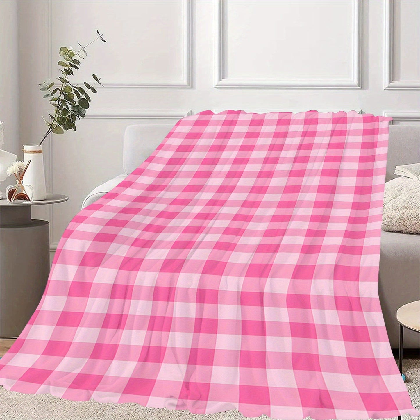 Soft and cozy polyester knit pink gingham flannel throw blanket. Ideal for adding a touch of contemporary style to your bedroom, sofa, or living room decor. Perfect for all-season use and makes an ideal gift for girls, daughters, and sisters. Features a