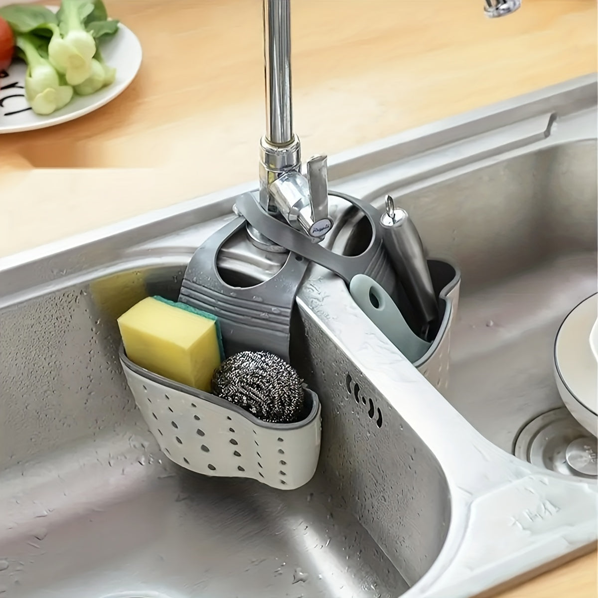 One piece of a multifunctional kitchen sink drain basket and rack, which can hang on the sink and be extended for holding tableware, fruit, vegetables, drying dishes, and storing soap and sponges. An essential item for organizing your kitchen supplies.