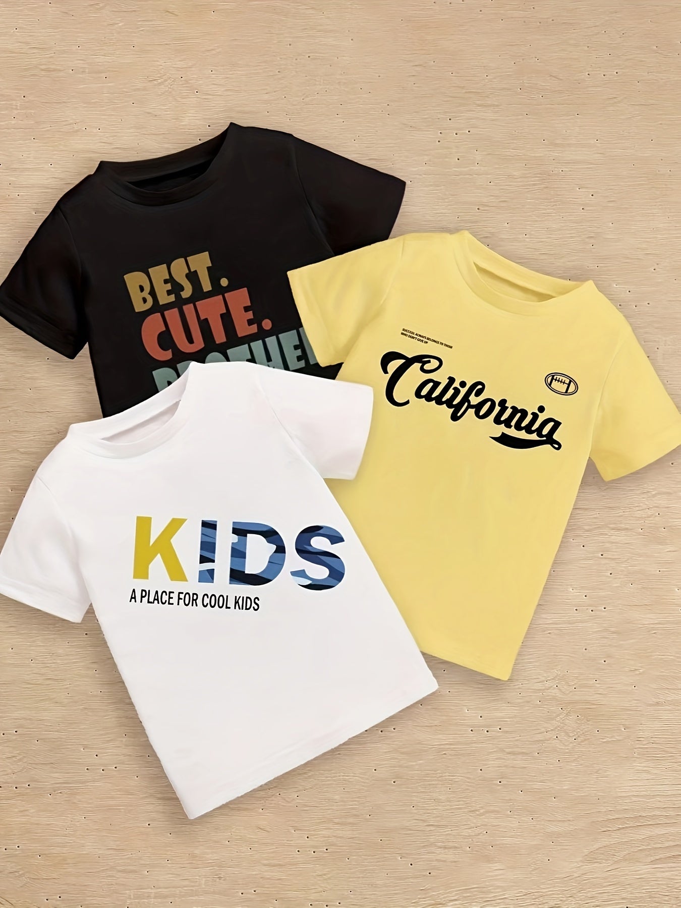 5-piece boy's summer casual tee with various prints: 'USA', calligraphy letter pattern, 'KIDS...', 'BEST CUTE...', and 'CALIFORNIA...'. Cool, comfy, and versatile gift option.