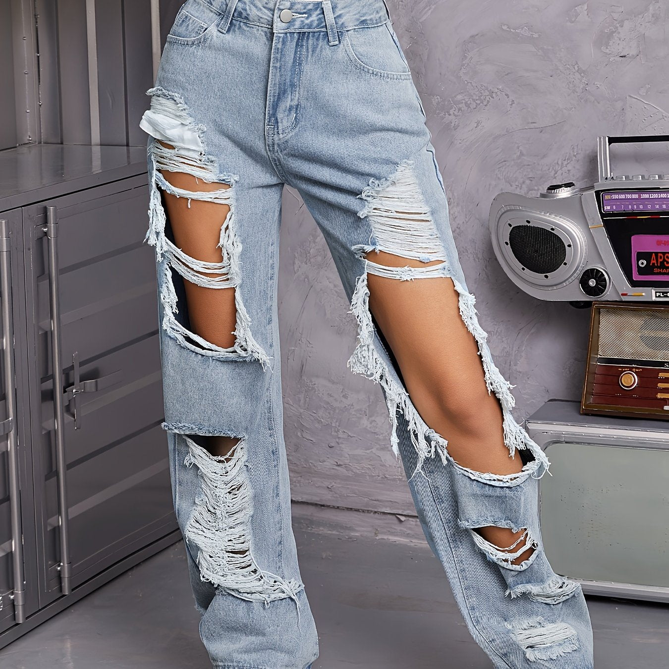 Vintage high-waisted distressed jeans for women in light blue wash, featuring a casual loose fit with pockets.