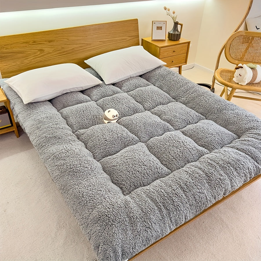 Soft, reversible gray mattress protector with corner straps for easy storage and transport. Ideal for cozy bedrooms.