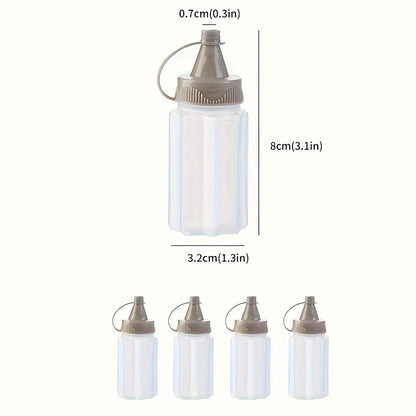 Set of 4 mini transparent seasoning bottles with gray lids, made of food-grade plastic for sauces and dressings. Portable and reusable squeeze containers for BBQs and kitchen use, hand-wash only.