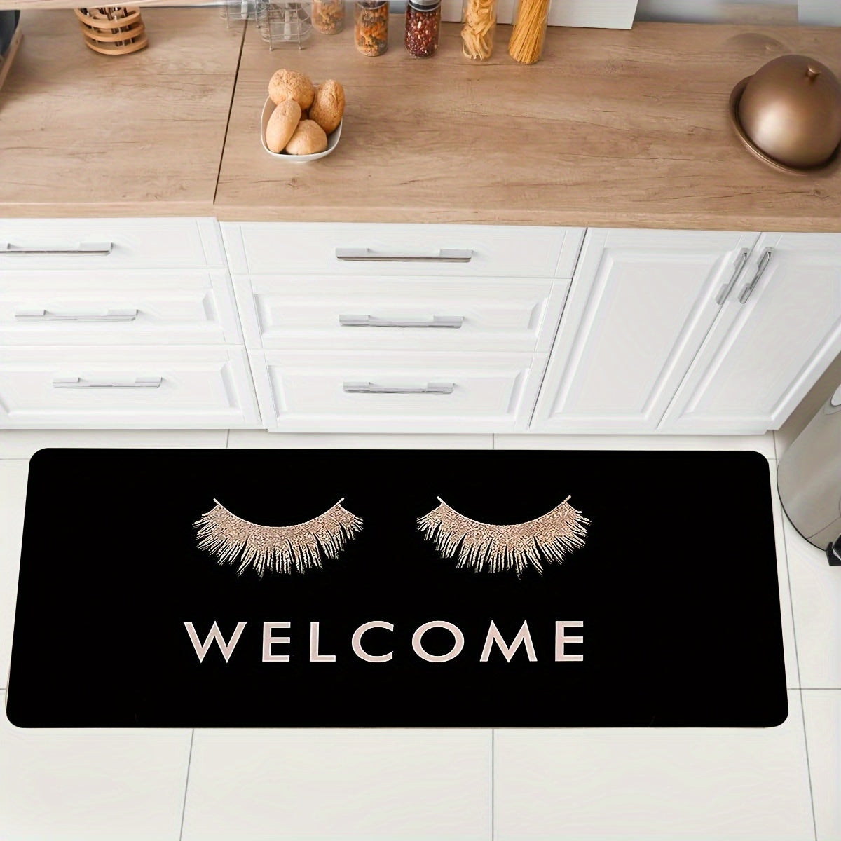 Pink eyelashes and letters patterned kitchen rug made of polyester vinyl material. This mat is anti-slip and absorbent, perfect for use in the kitchen, home office, sink area, or laundry room. It also provides anti-fatigue properties for added comfort.