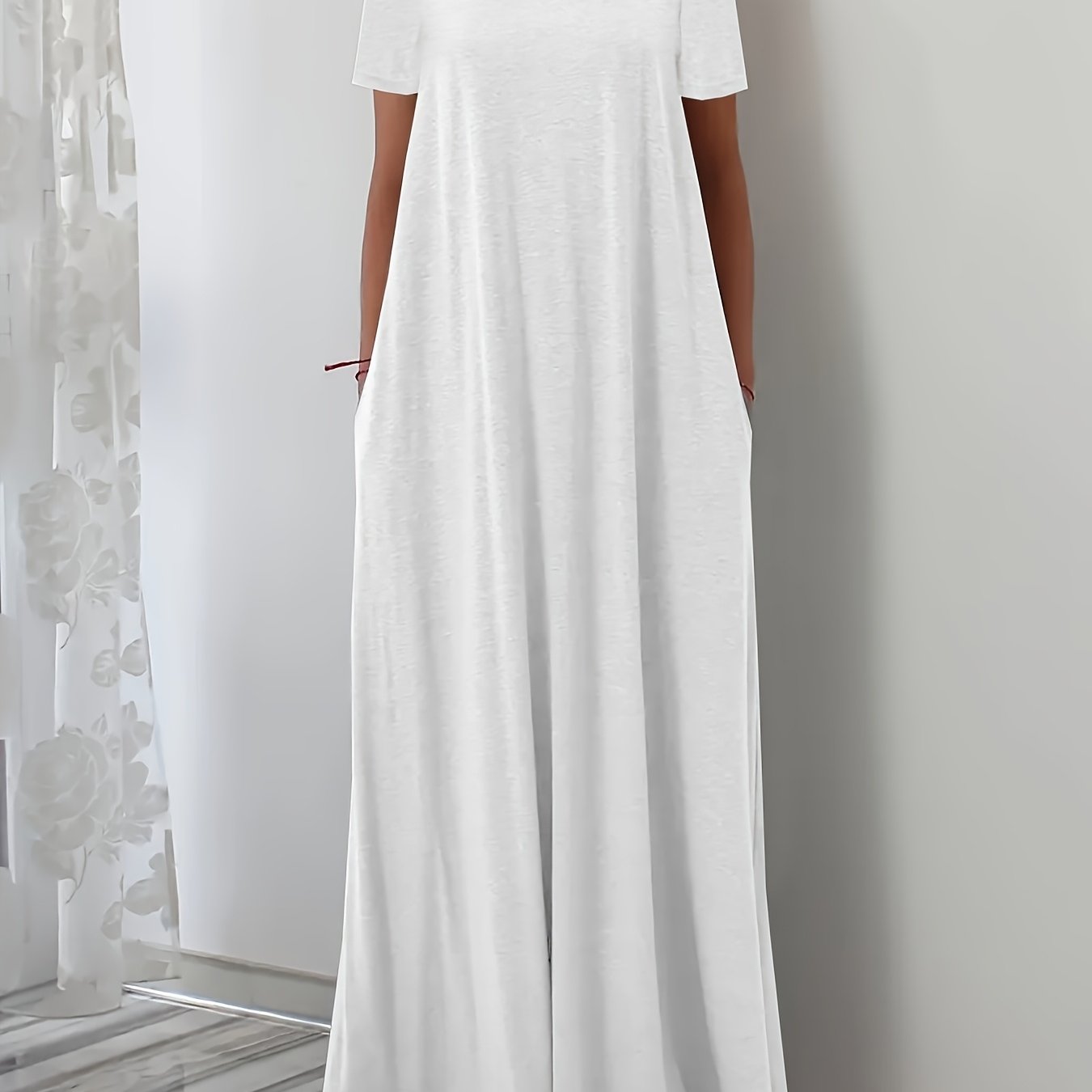 White maxi dress with square neck, short sleeves, pockets, and flowing silhouette made from stretchy polyester blend. Ideal for spring, summer, and fall.