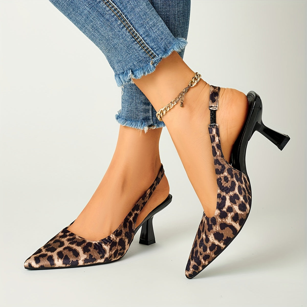 Leopard print stiletto sandals with pointed toe, slip-on style, and high heels in black and brown animal pattern. Comfortable for fall fashion.