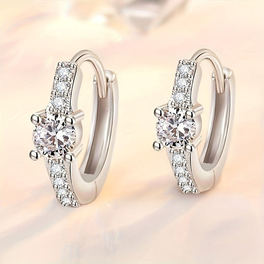 A stylish pair of retro-inspired S925 Silvery earrings, featuring exquisite rhinestones set in round hollow centers. These high-end and trendy accessories boast a luxurious shine, perfect for adding a touch of elegance to any outfit. With a sweet and