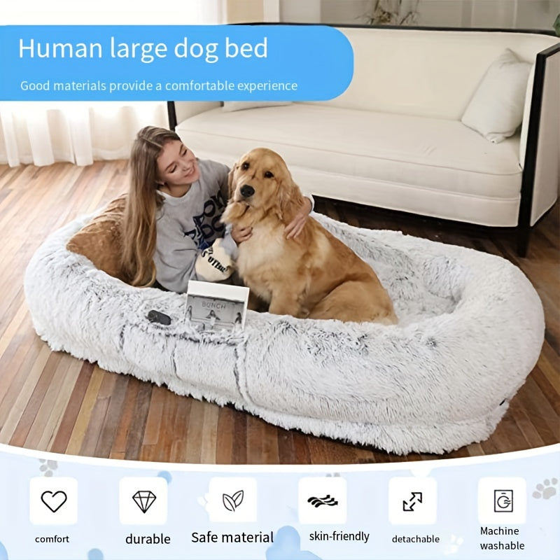 Oval-shaped plush sofa bed for dogs and people, cozy and warm with a non-slip bottom and machine washable in gray color.