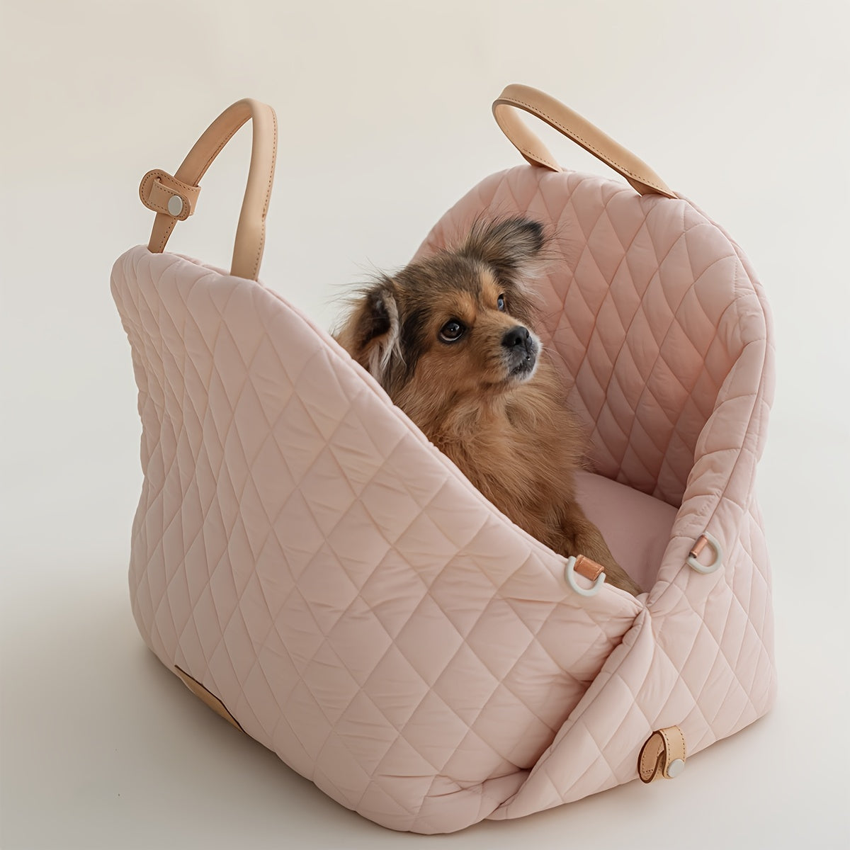 Versatile pet carrier bag doubles as a dog car seat for safe travel with a harness attachment. Carry your dog or cat securely.