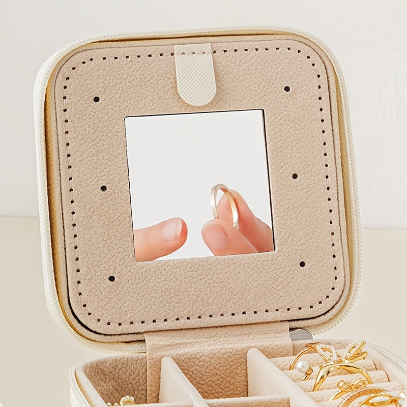 Compact and stylish portable jewelry box with mirror, zipper, and flip cover. Ideal for storing rings, earrings, and necklaces on-the-go.