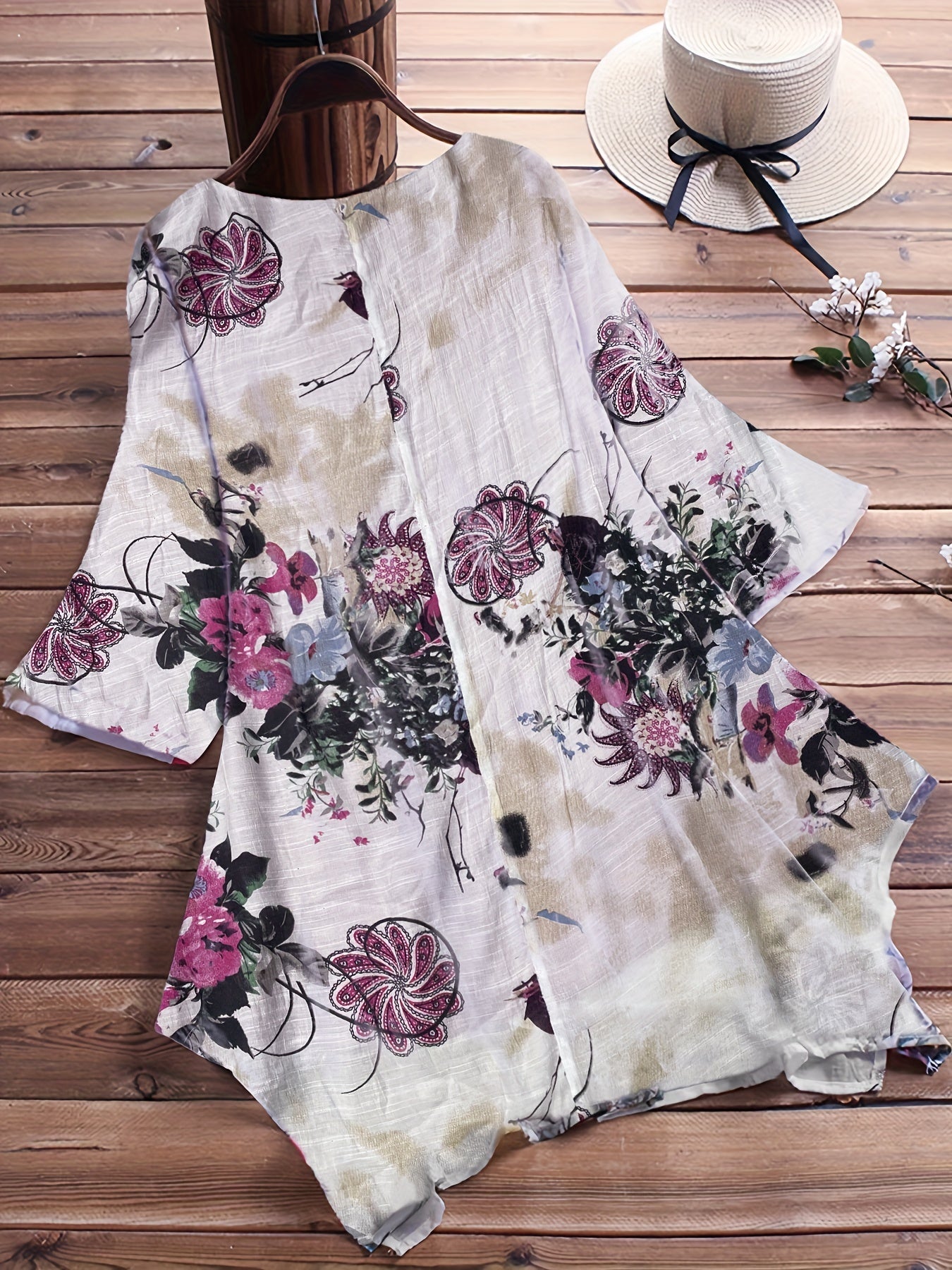 Women's plus size casual top with floral print, short sleeves, V-neck, and asymmetrical hem.