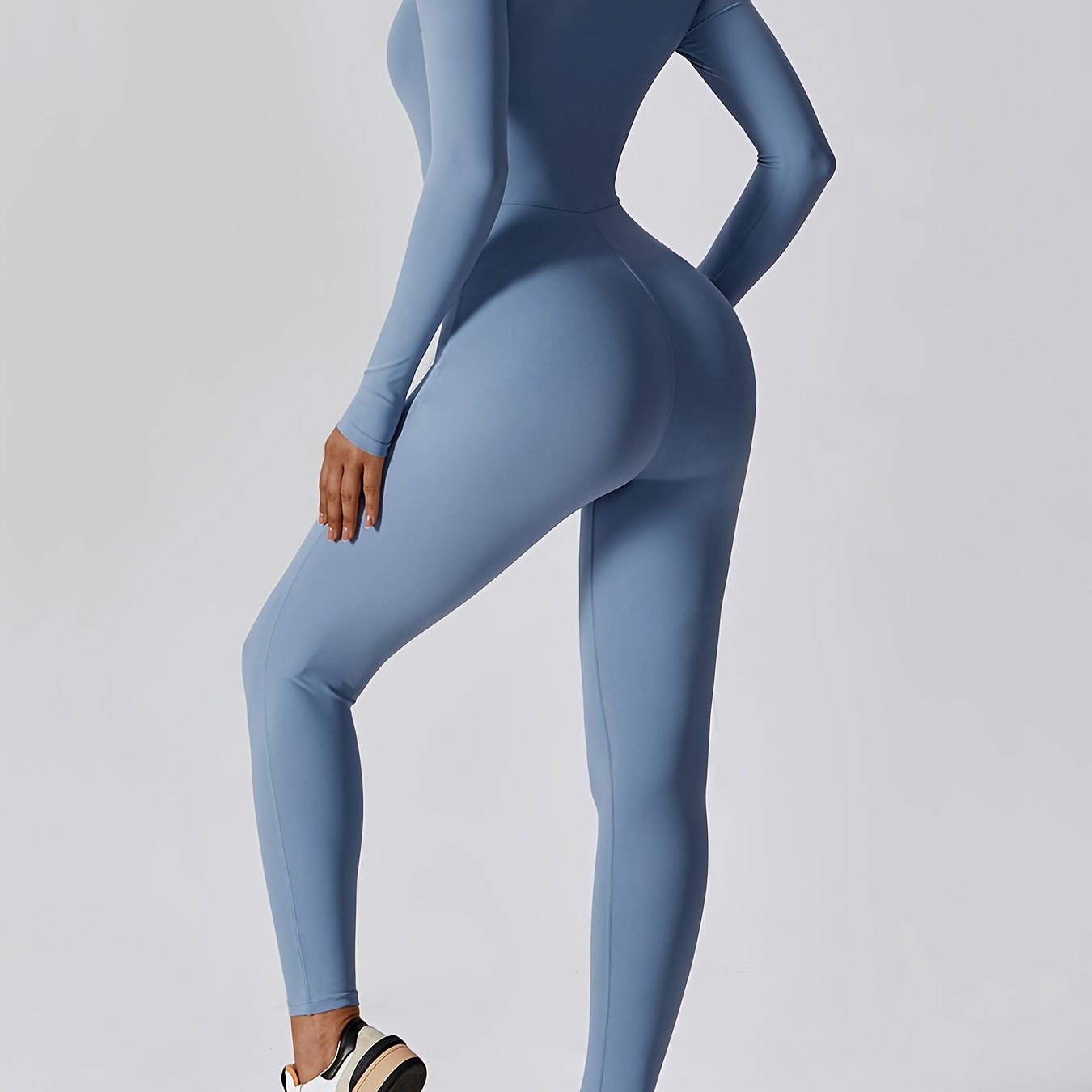 Long-sleeved yoga jumpsuit for women, solid color, slim fit.