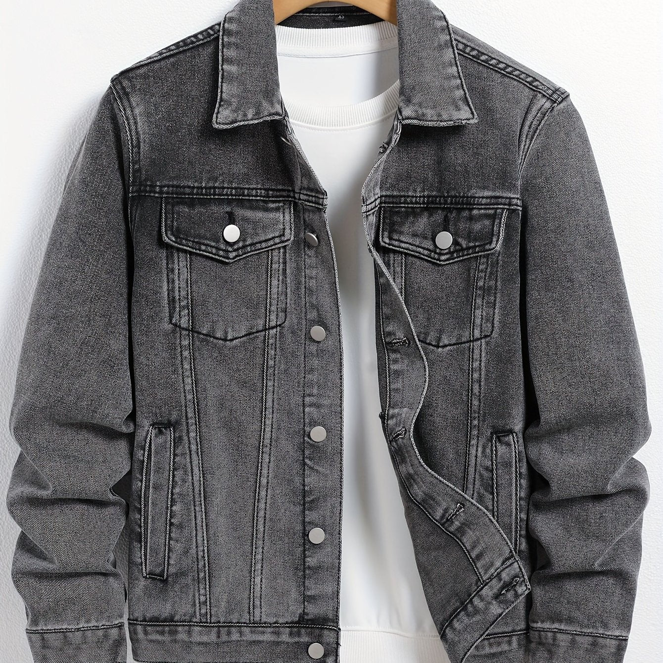 Plus size men's casual denim jacket in solid color made from a cotton blend with lapel collar, utility pockets, and regular fit.