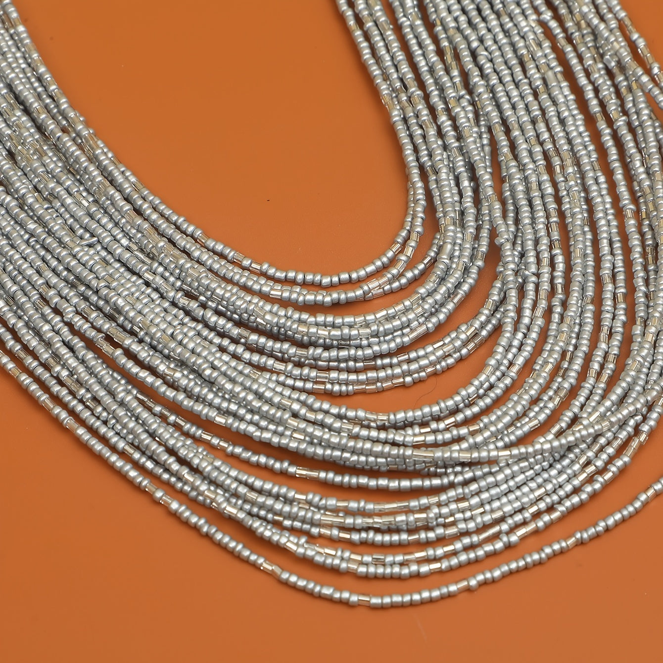 A trendy and flexible millet bead necklace with multiple layers.