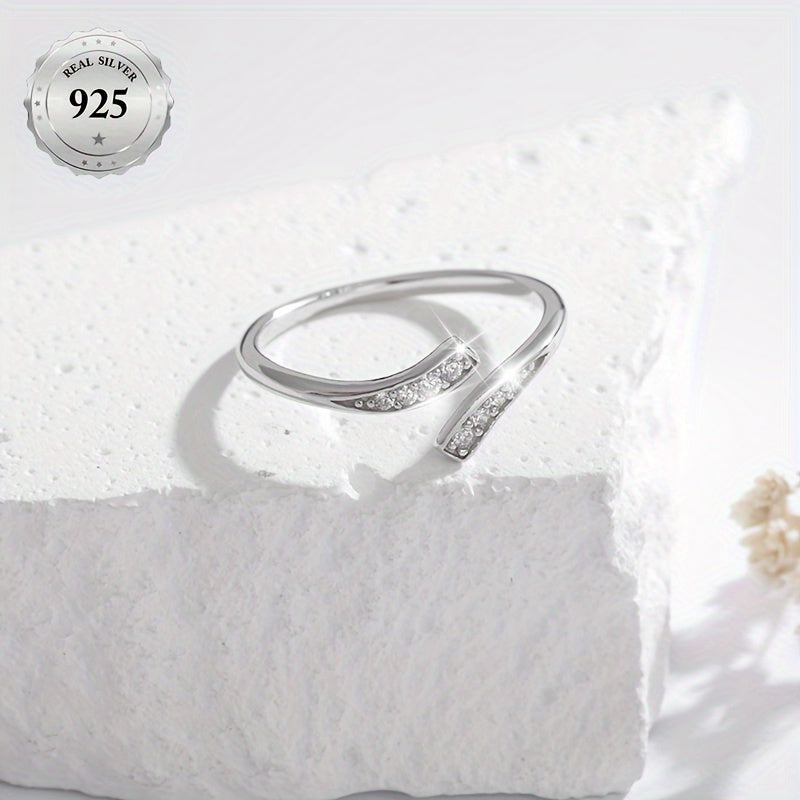 A stylish women's open ring featuring an infinity symbol and an endless loop design adorned with sparkling synthetic cubic zirconia for added bling. This minimalist and classic piece is made from lightweight 1.5g 925 sterling silver, making it suitable