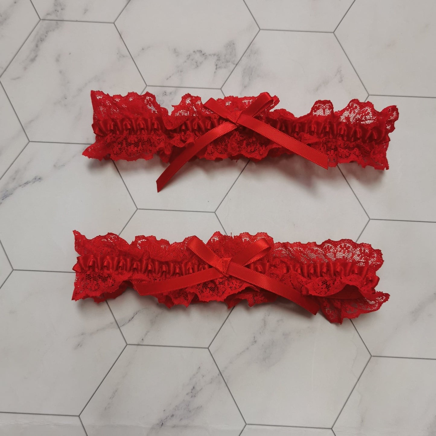 Floral lace thigh garter belt with bow tie detail, perfect for adding a touch of sexy to your lingerie collection.