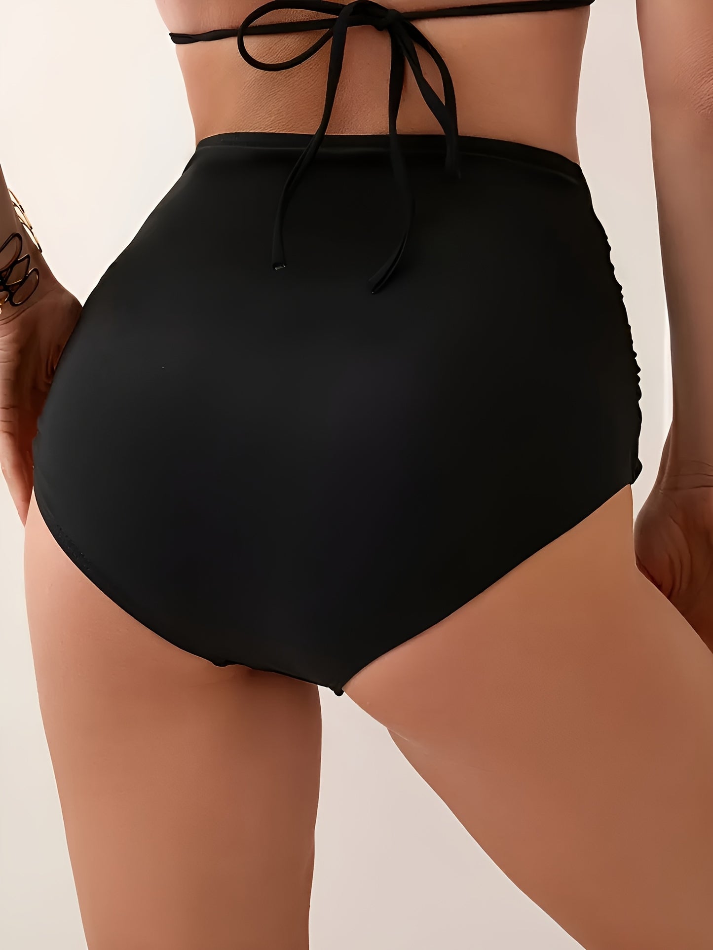 Stylish high-waisted swim bottoms for women made of a polyester and elastane blend. Features frill detail, solid color, high stretch, and knit fabric.