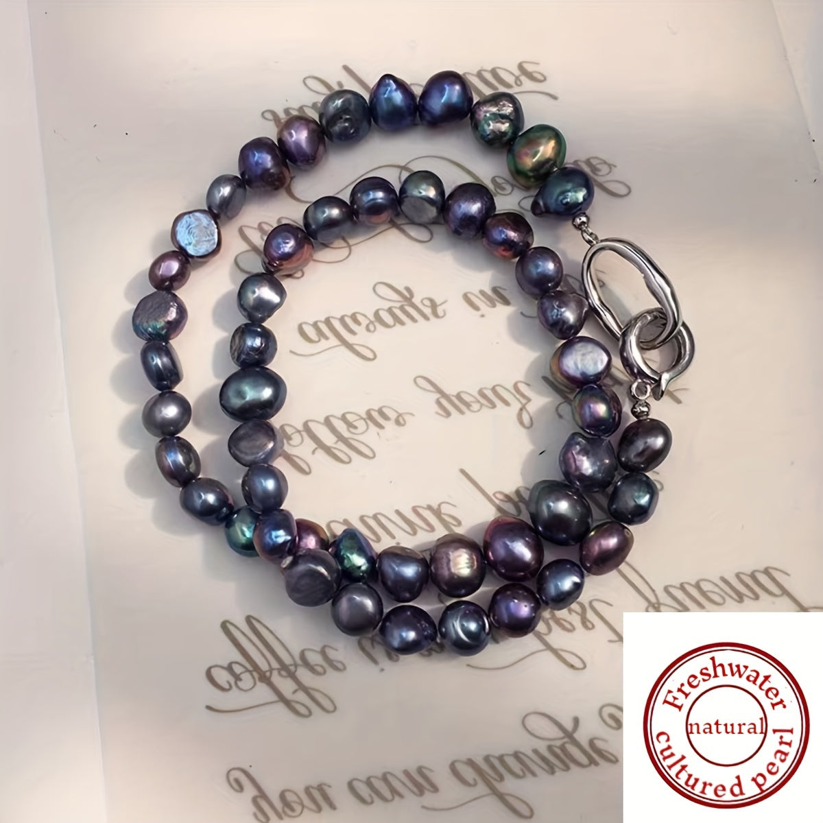 This necklace features a beautiful, natural freshwater cultured pearl measuring 7-9MM in a stunning blue-black hue. The clavicle length necklace is designed for women and showcases irregular baroque pearls with a unique texture and shape. Each pearl is