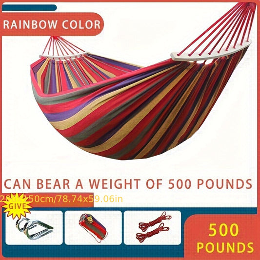 Heavy-duty rainbow canvas hammock for single or double with curved wooden sticks and a weight capacity of 226.8 KG. Includes tree straps for camping, backyard, or patio. High-strength