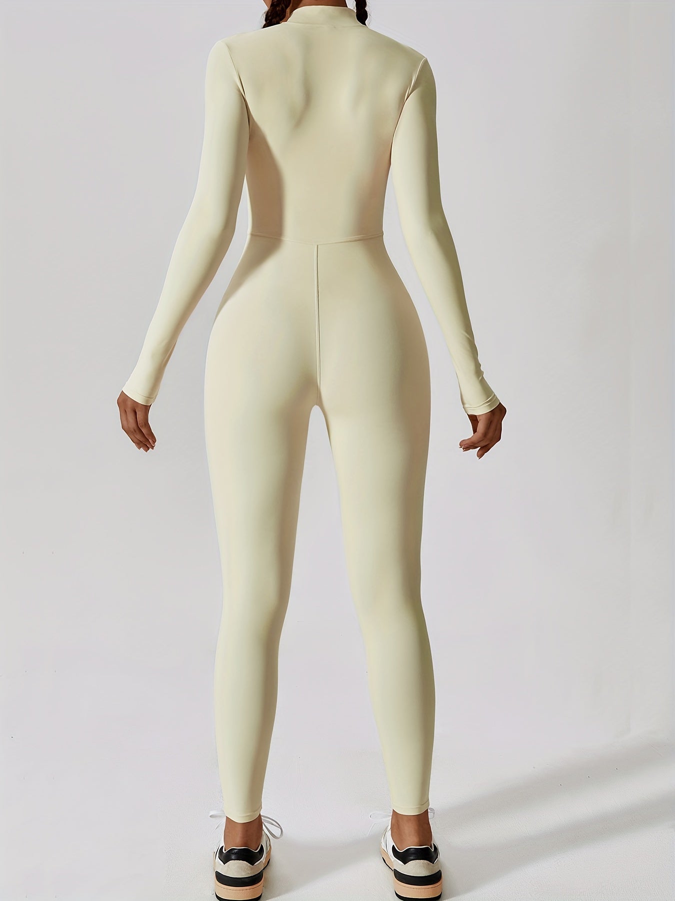 Long-sleeved yoga jumpsuit for women, solid color, slim fit.