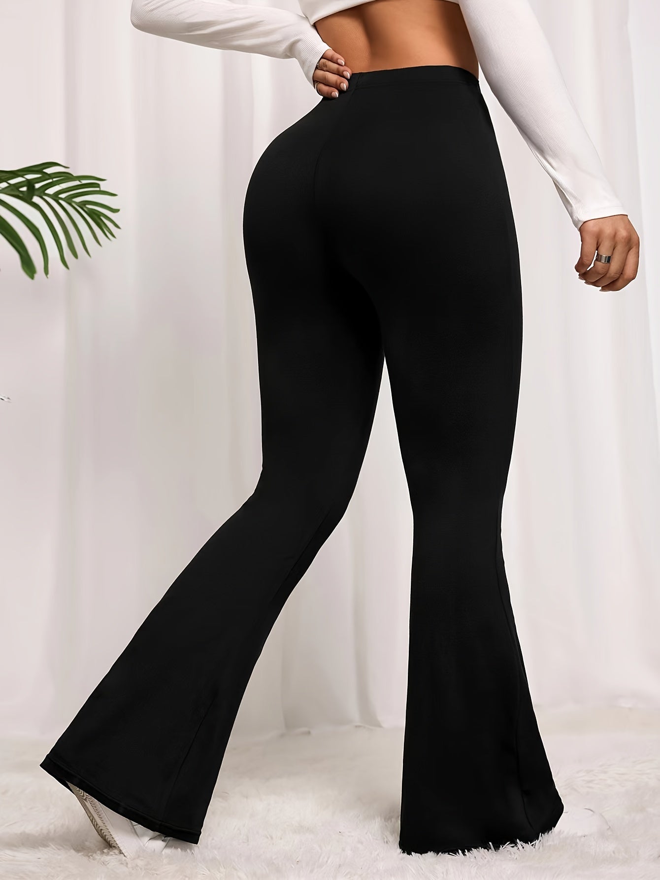 Solid color flared leg pants with a high waist, perfect for spring and summer in plus size women's clothing.