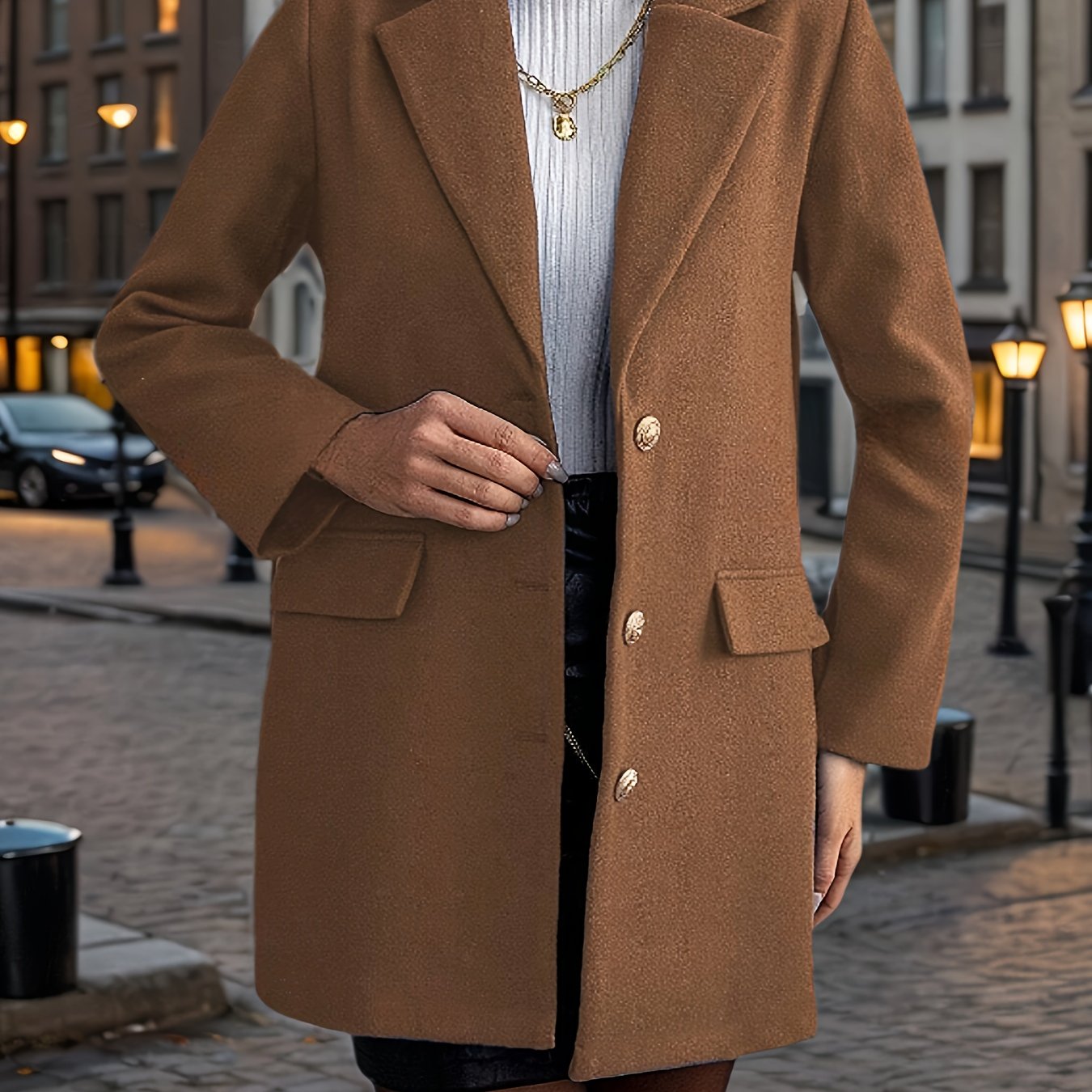 A stylish women's coat with a notched lapel, long sleeves, single-breasted closure, and fake pockets, made of polyester woven fabric for fall/winter outerwear.