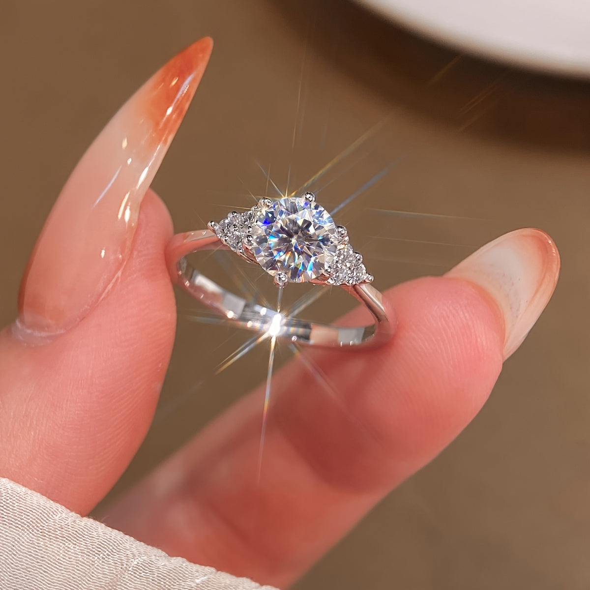 This elegant Moissanite engagement ring features a 1CT stone set in 925 sterling silver, with a silvery gram weight ranging from 5-9 yards. The shining Moissanite wings add a touch of luxury, making it the perfect gift for a loved one on Valentine's Day