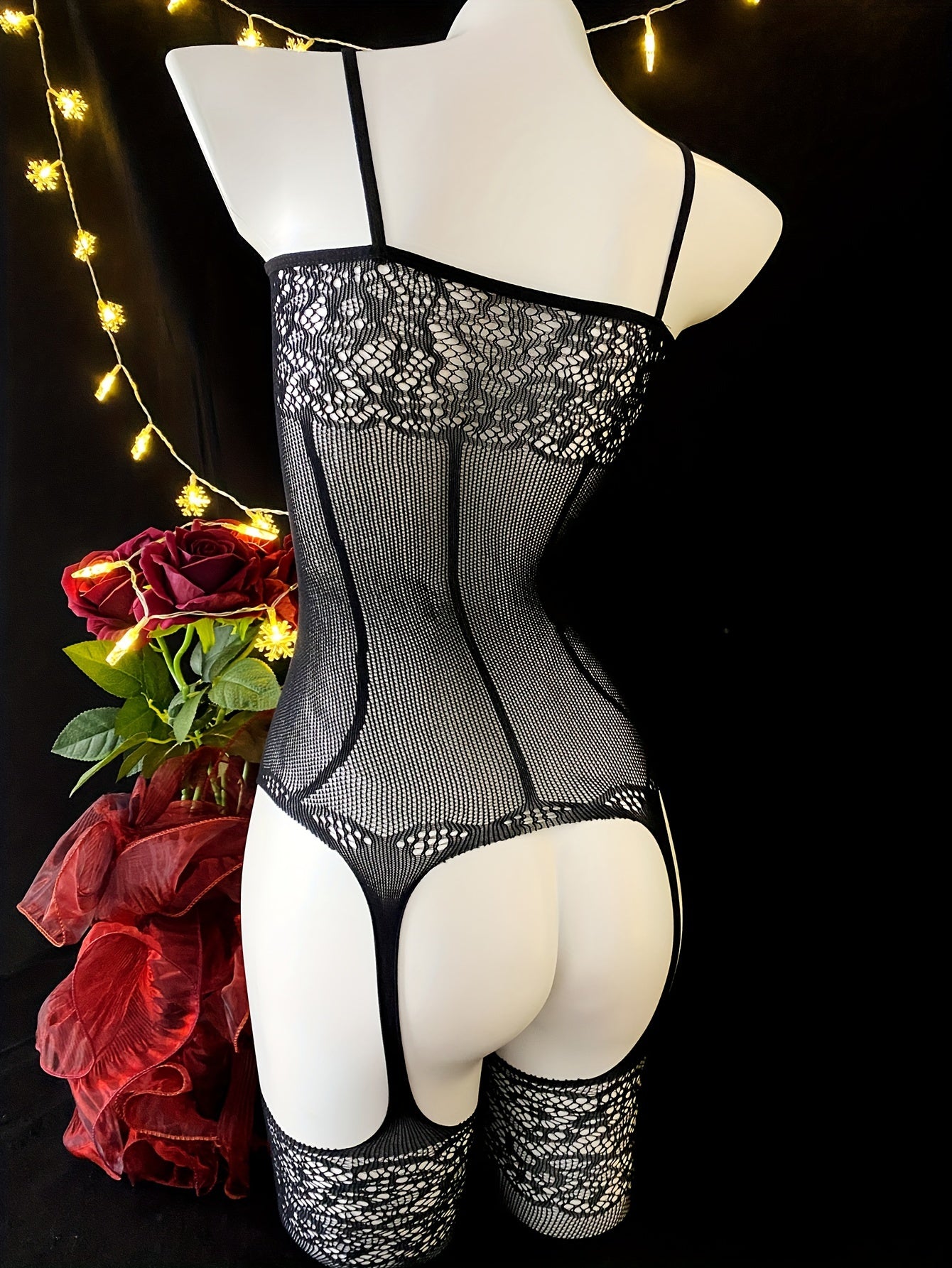 Black lace bodysuit for women with sexy hollow-out design, high-stretch nylon/elastane blend, hand washable. Ideal for music festivals and beachwear.