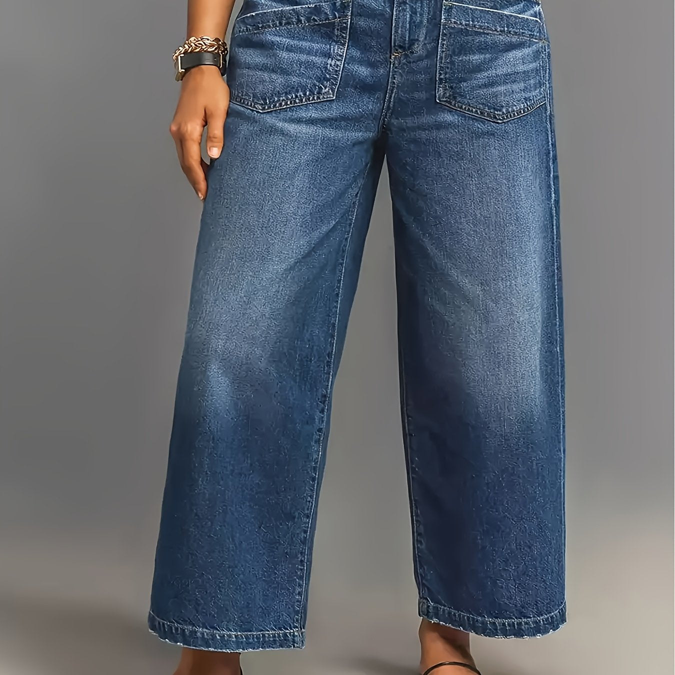 Wide leg high-waisted denim jeans for women in soft blue cotton with slant pockets, loose fit, and mid-rise. Comfortable for all seasons.