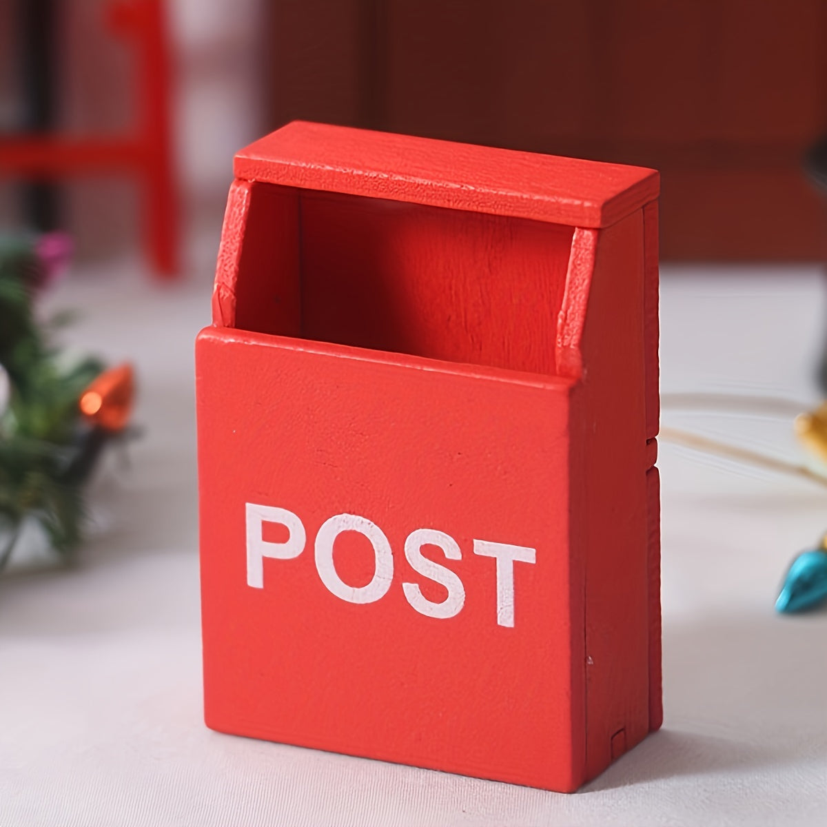 Red miniature wooden mailbox for 1:12 dollhouses with "POST" label, indoor use, no power required. Perfect for living room decor.