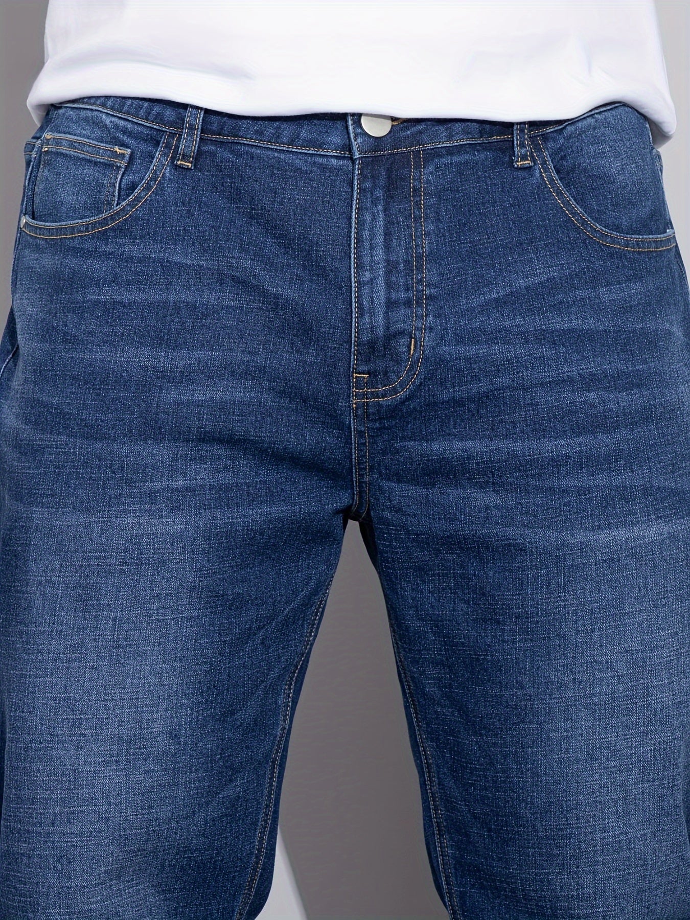 Men's stretchy cotton denim pants for all seasons, in a loose fit and plus size, perfect for business casual wear.