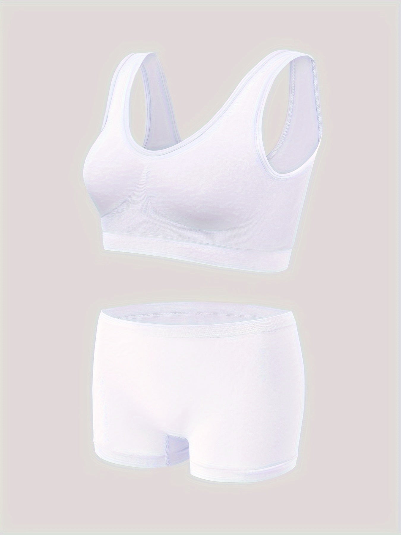 Seamless sports bra and high-waisted shorts set in breathable nylon with spandex blend, wire-free and padded, solid color casual adult pajama set.