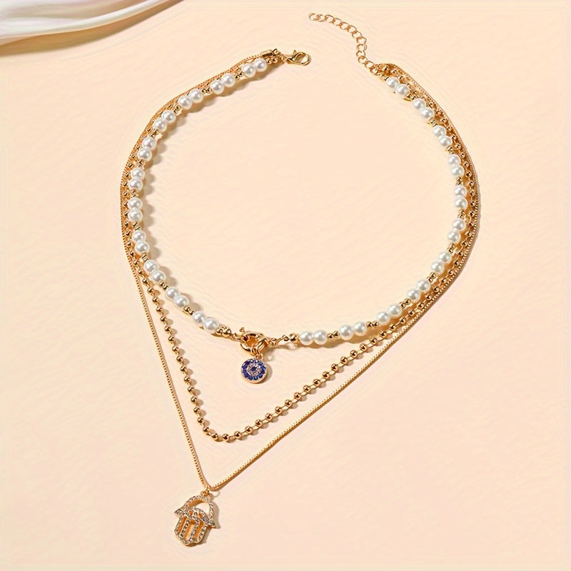 Multi-layered imitation pearl necklace featuring evil eye and Hamsa hand pendants, designed in classic punk style. Made with synthetic stones, alloy material, and no plating. Suitable for both men and women for everyday and vacation wear. Can be worn in