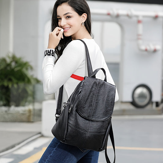 Women's black genuine leather backpack with adjustable strap, drawstring closure, and polyester lining.