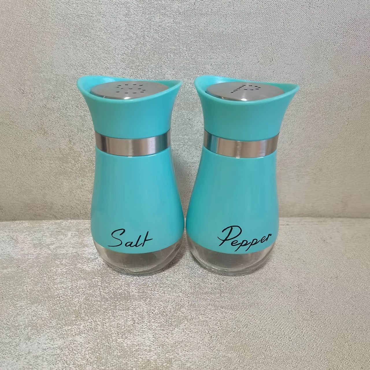 1 set of 4 ounce glass salt and pepper jars with stainless steel lids, perfect for kitchens, tables, RVs, campsites, and barbecues. Refillable design.