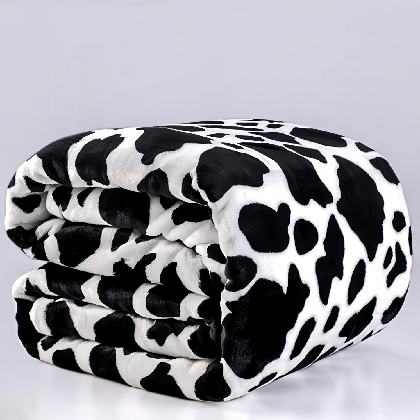 Get cozy with this Cow Printed Flannel Blanket - the perfect gift for a loved one. This double-sided blanket is warm and soft, ideal for snuggling up on the couch, bed, or sofa. It's also great for staying warm while traveling or using as an air