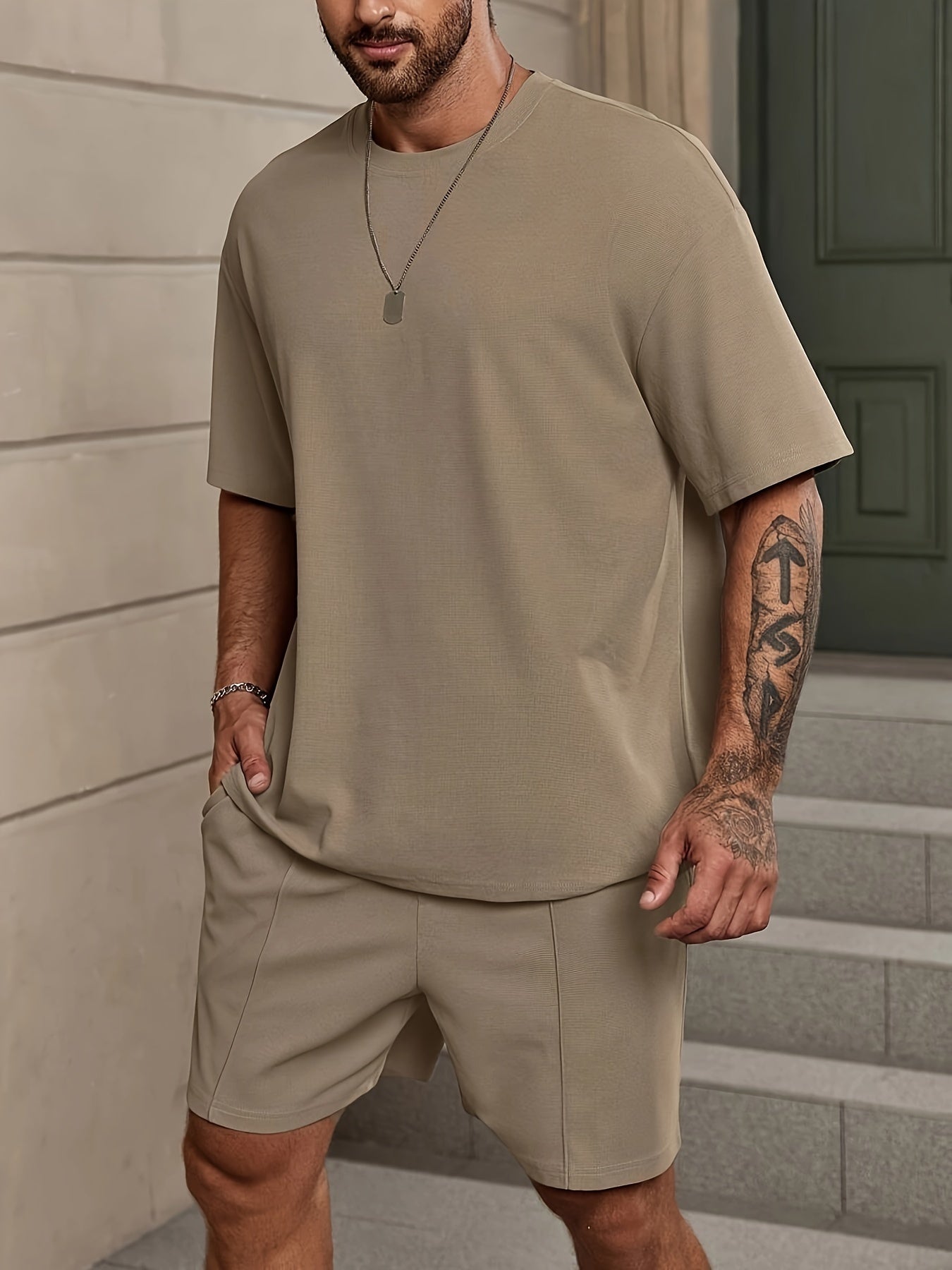 Men's 2-piece solid color summer outfit set includes short sleeve crew neck t-shirt and elastic waist shorts with pockets.