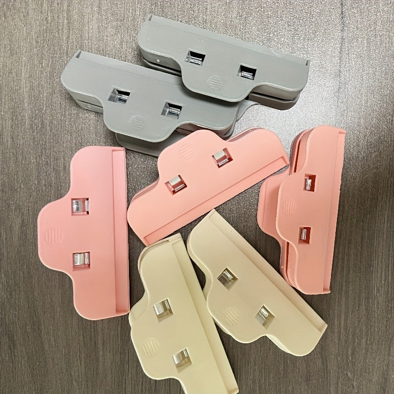 Set of 5 ABS Plastic Bag Clips in various colors for large, durable sealing in the kitchen. Keep snacks fresh with these beige, pink, light gray, and dark blue/black clips.