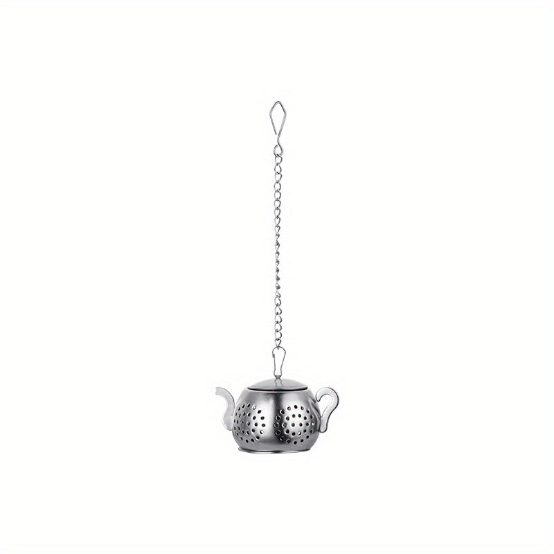 Golden rose stainless steel teapot-shaped tea strainer with uniform filter holes and hanging chain for cups.