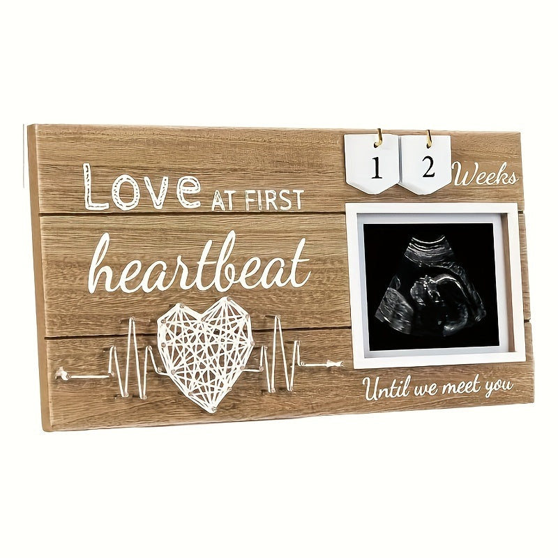 Baby countdown photo frame made of wood featuring a heartbeat design. This newborn keepsake frame is suitable for children aged 0-3 years and comes with interchangeable week tracker blocks.