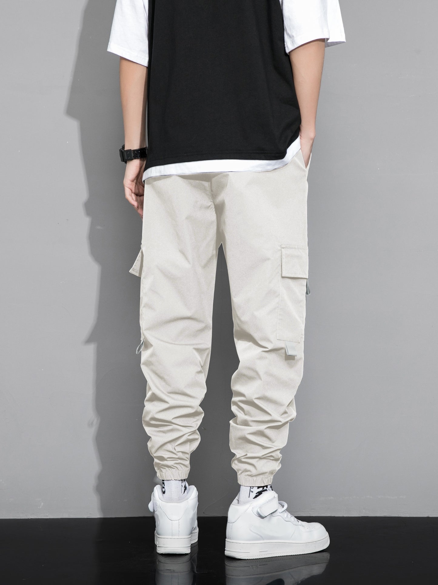 Stylish cargo pants with multiple pockets for men, featuring a loose fit and drawstring waistband for a casual outdoor streetwear look.