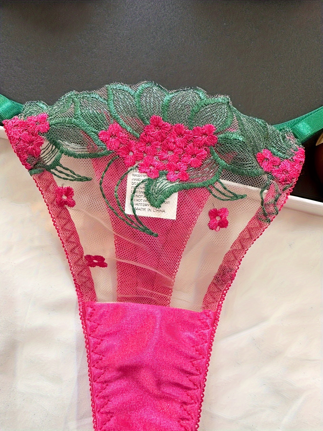 Floral embroidered mesh lingerie set for adult women, made of 95% polyester and 5% elastane.