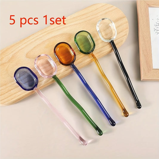 A collection of 5 whimsical transparent coffee spoons in pastoral colors, perfect for stirring milk or desserts. These high-temperature resistant glass spoons feature cute long handles and are great for stirring coffee.