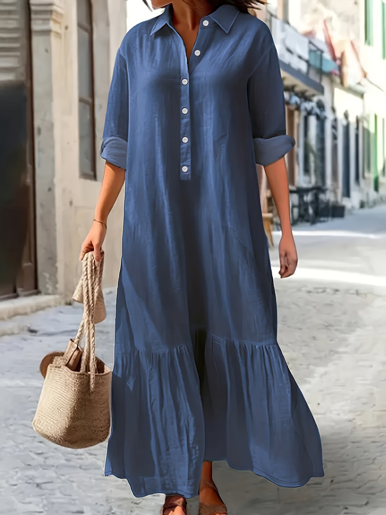 Maxi denim dress in washed blue for plus-size women, with ruffled hem and button-up long sleeves.