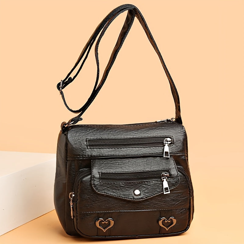 Ladies' faux leather crossbody bag with adjustable strap and magnetic closure.