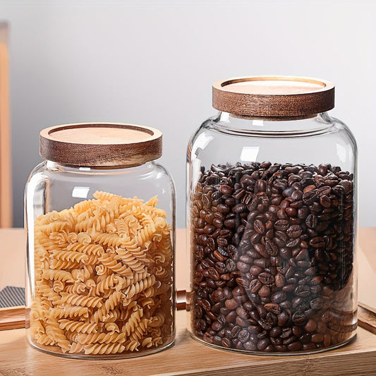 Large glass food storage jars with airtight wooden lids for storing coffee beans, dried food, pasta, tea leaves, overnight oats, grains, and spices. These clear glass canisters are perfect for organizing your kitchen and keeping your ingredients fresh.